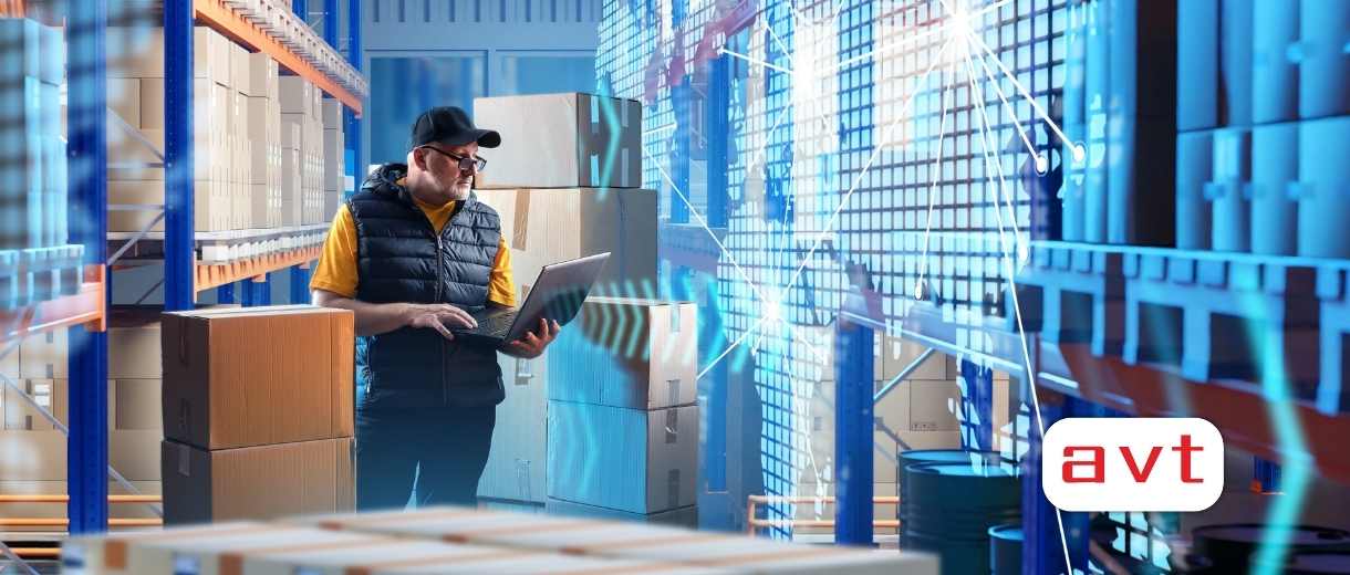 man with laptop works in warehouse